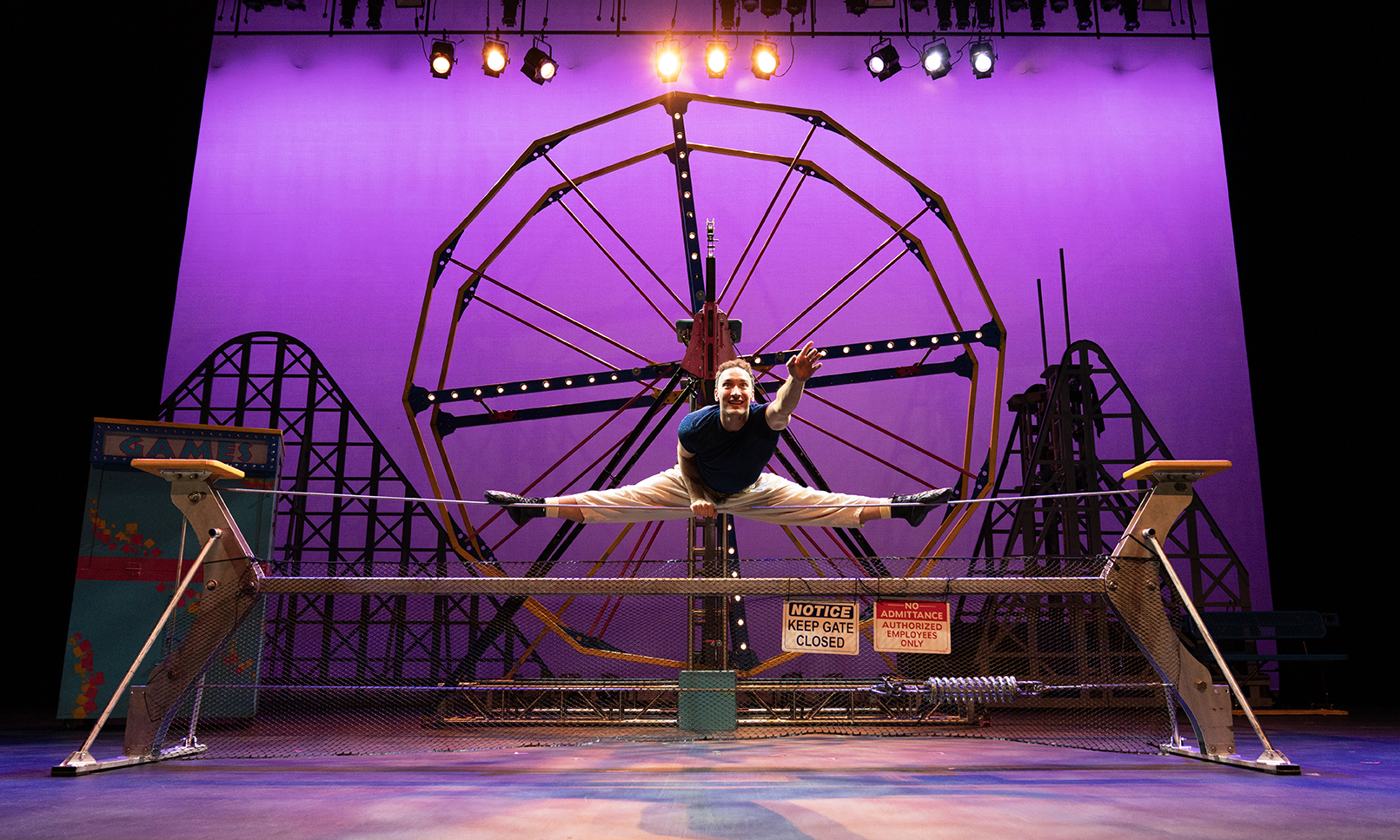 Performer straddling a wire in the Cirque Mechanics: Tilt! performance