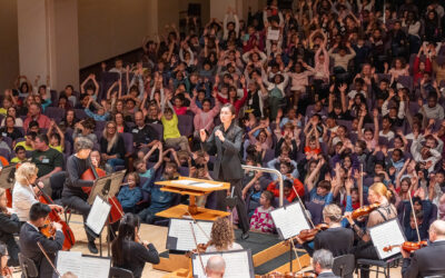 NC Symphony performing an educational concert in front of a school audience full of children.