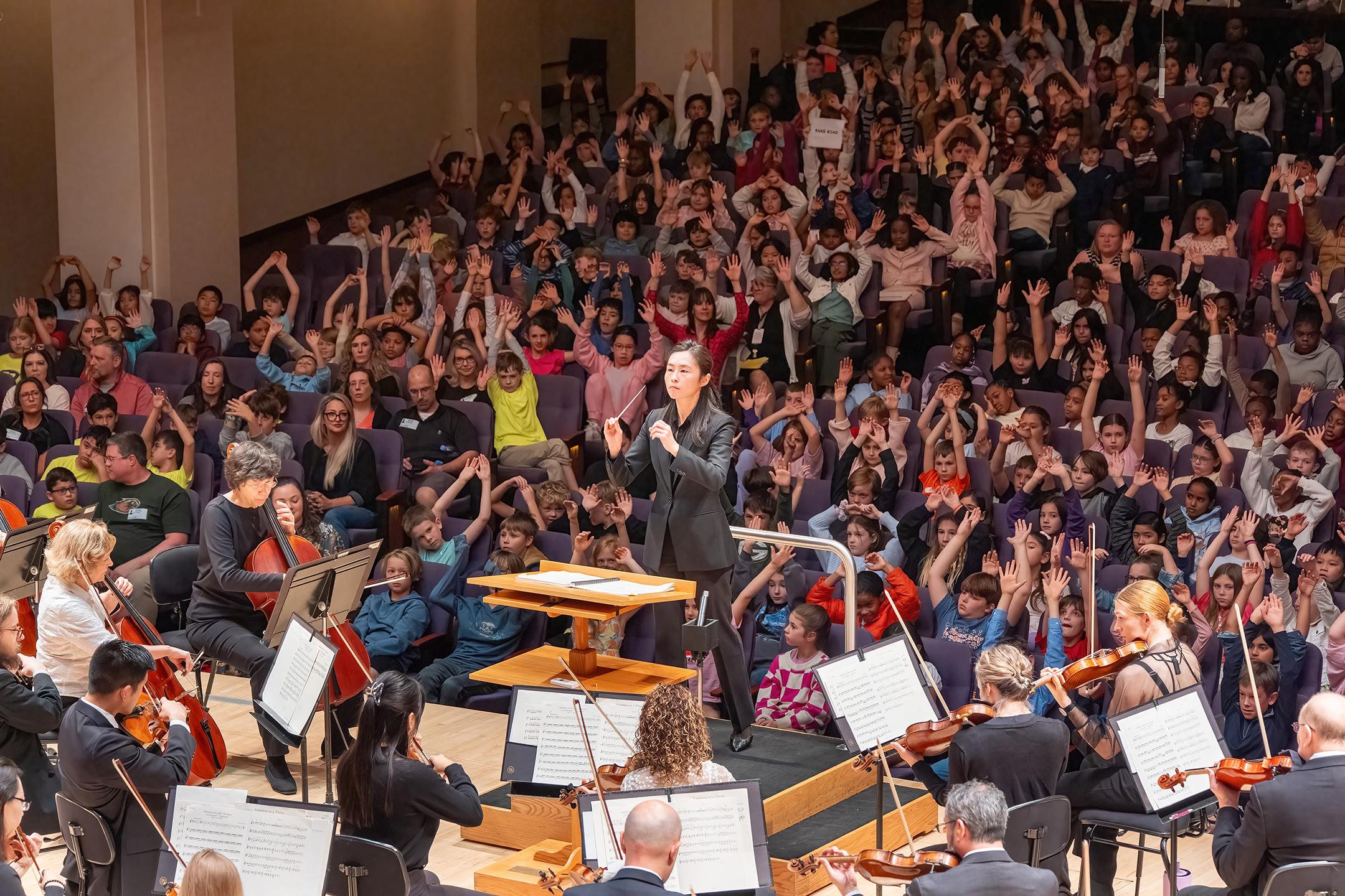 NC Symphony performing an educational concert in front of a school audience full of children.