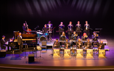18 student jazz musicians playing sax, horns, drums, and piano